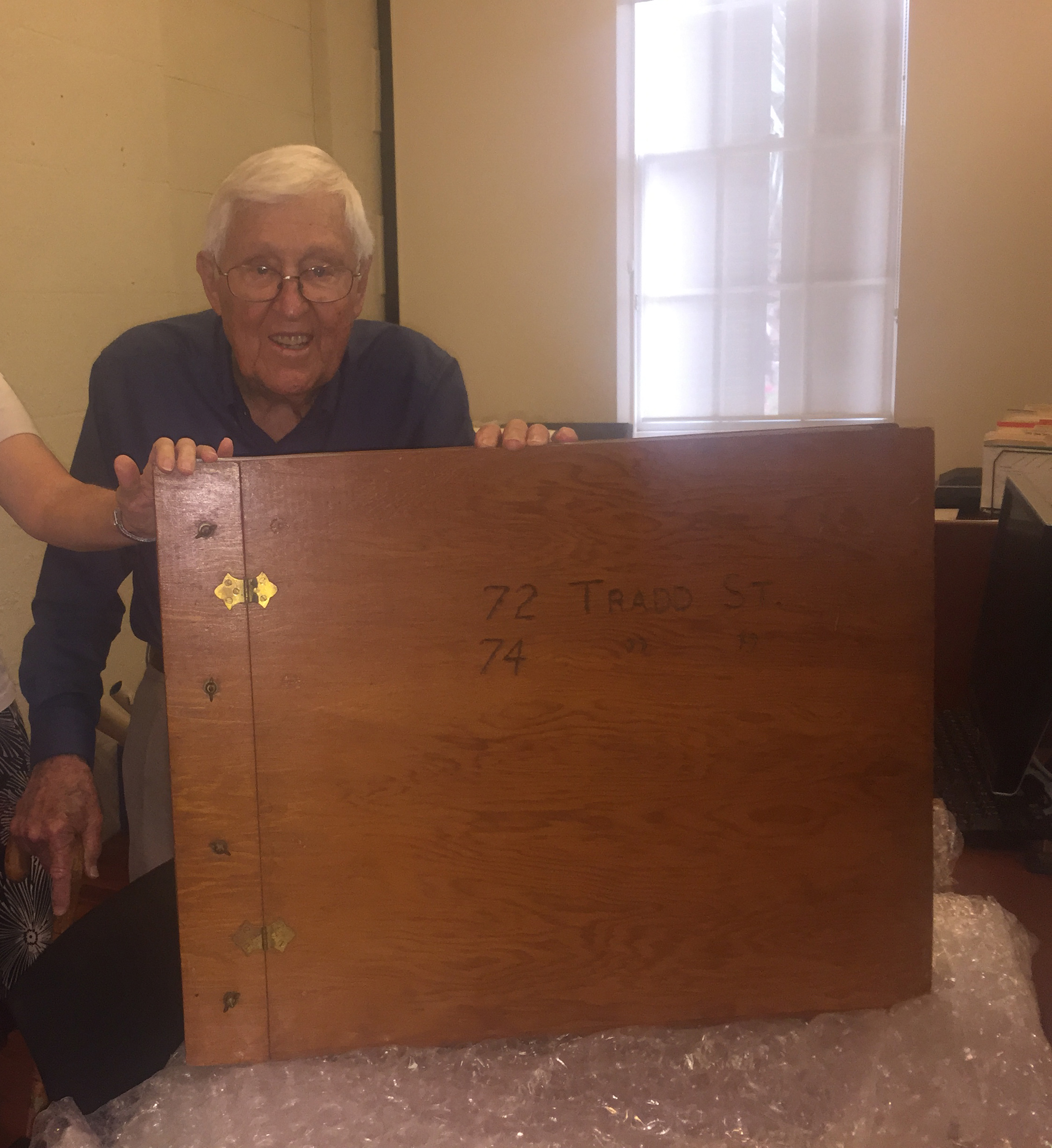 Thomas Thornhill with the book containing documents regarding two Tradd Street houses in Charleston, SC.